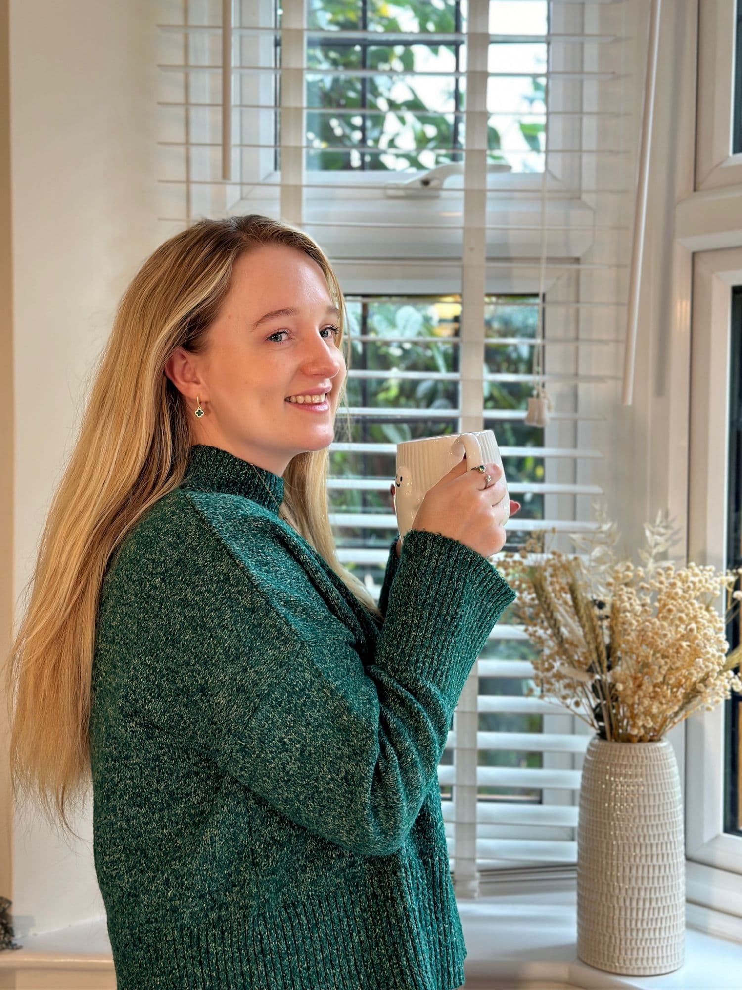 Sophie Pilley smiling with a cup of coffee